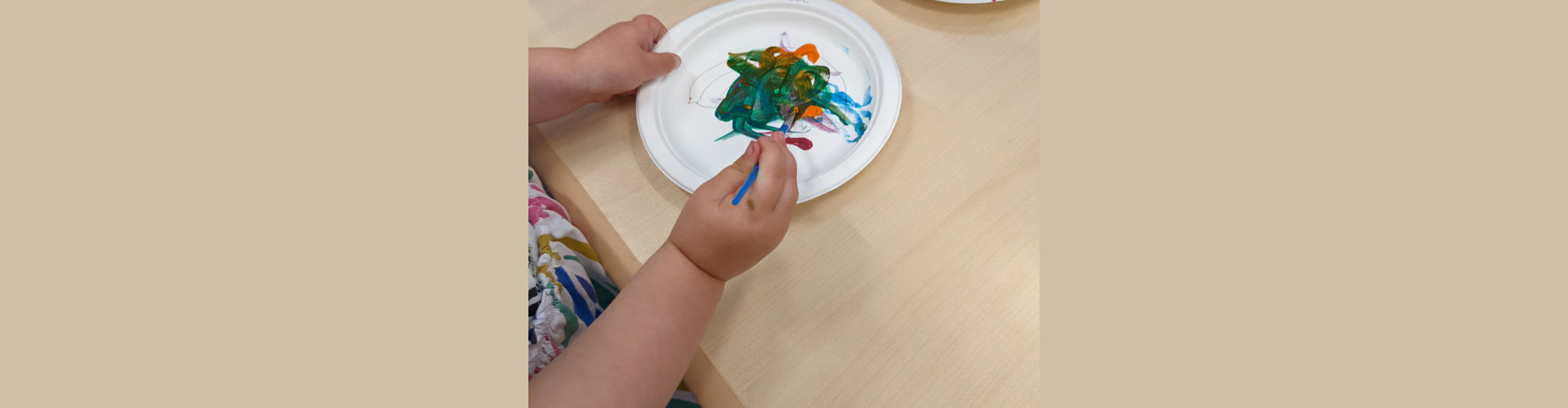 baby playing colors on plate